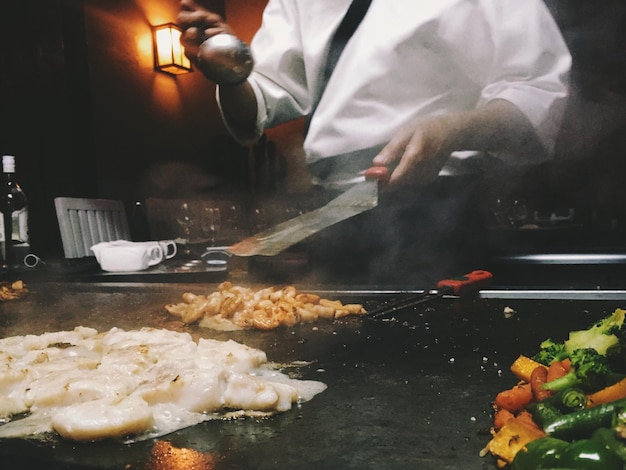Midsection of chef cooking in kitchen